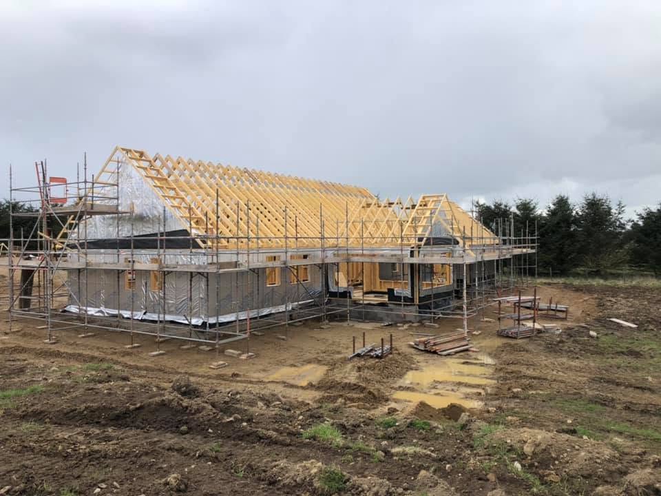 House under construction with roof trusses