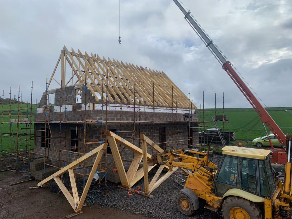 House under construction with roof trusses